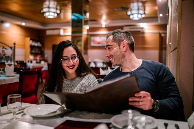 People looking at a menu